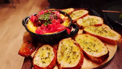 dish of slices of rustic bread with oil and oregano with sauce