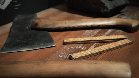 vintage ax and measuring tools on a wooden surface