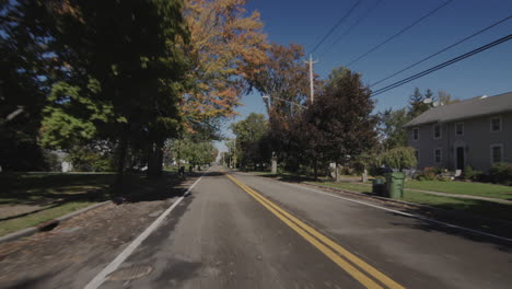 drive forward on a road through a typical american city. rear window view