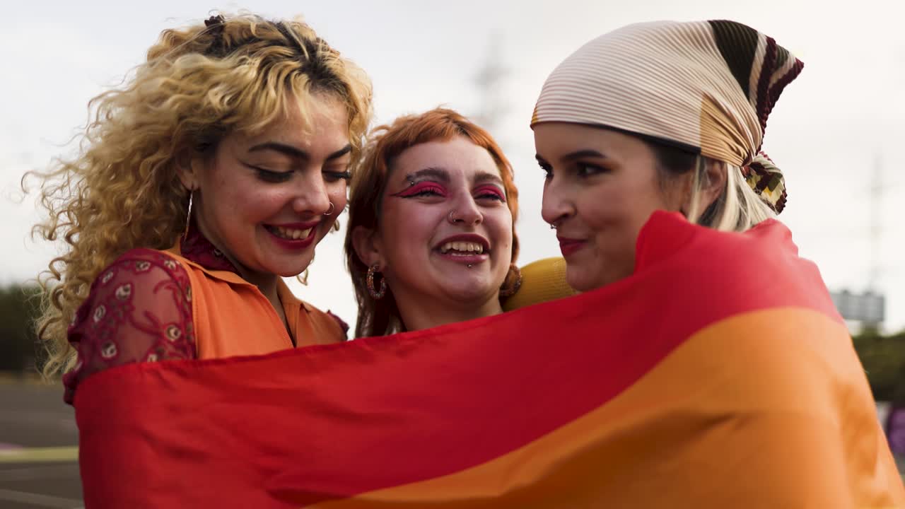 Happy young girls celebrating gay pride festival - LGBT community concept