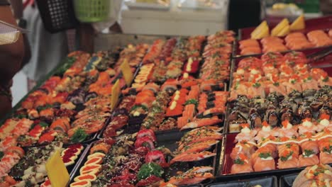 Colorful-and-fresh-japanese-sushi-sold-in-a-thai-street-market-in-Thailand