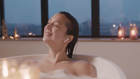 Woman-Listening-To-Music-With-Earphones-While-Taking-A-Bath-In-The-Bathtub