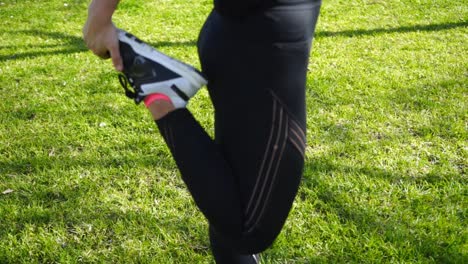 athletic girl in sportswear exercising in park