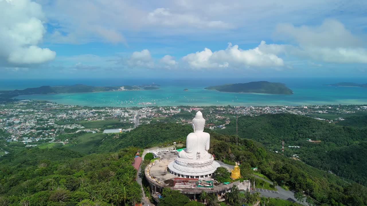 Aerial ascend push-back reveals The Big Buddha above Chalong Bay and Phuket hills