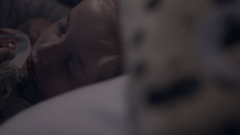 little girl sleeps peacefully in bed at night, focus pull