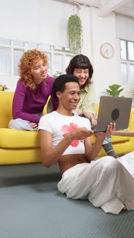 a group of friends using a laptop indoors
