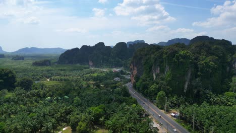 Tropical-landscape-karst-mountains-road-palm-trees