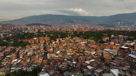 Aerial-view-over-ghetto-homes-in-Comuna-13,-sunny-evening-in-Medellín,-Colombia