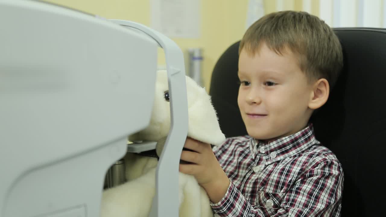 Children ophthalmology. Examining eyesight with optical equipment.