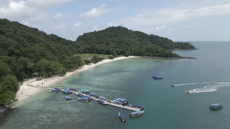 Aerial:-Tourists-on-tour-boat-pier-of-small-isle-in-Strait-of-Malacca