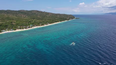 traditional philippines passenger boats at sun sea shore on turquoise ocean at tropical carabao island in romblon, philippines