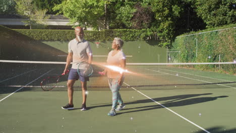 mature man and senior woman walking on tennis court, showing floating fitness chart and heart icons