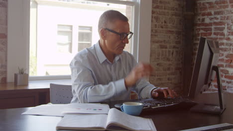 Mature Businessman Working On Computer In Office Shot On R3D