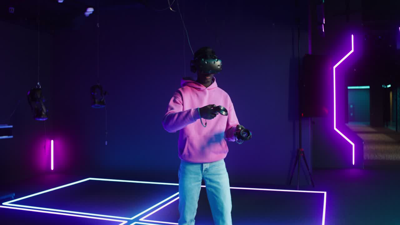 Man Experiencing Virtual Reality Gaming with VR Headset and Controllers