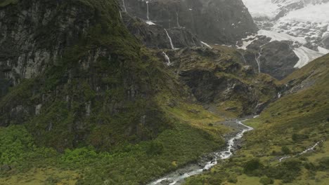 Scenic-nature-view-of-Rob-Roy-Glacier-valley-with-meltwater-river,-aerial