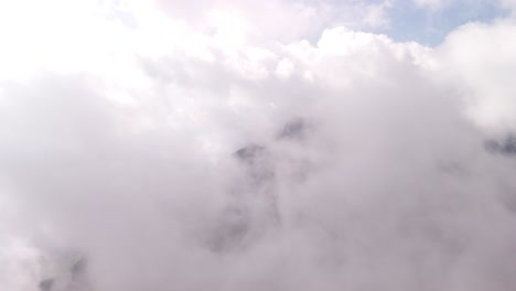 flying through clouds, fog smoke in the sky above swiss mountains switzerland