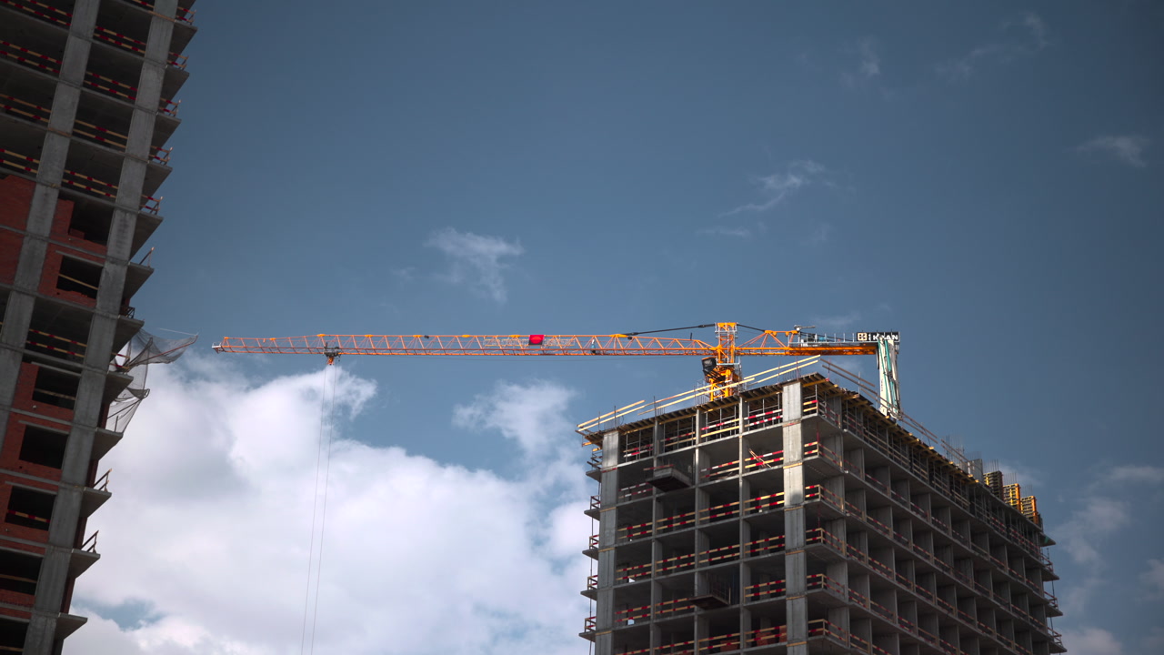 Tower Crane Reaches Over Skeletal Highrise, Heavy Metal Framework Against Dramatic Cloud Backdrop, Hoist Lines . Media