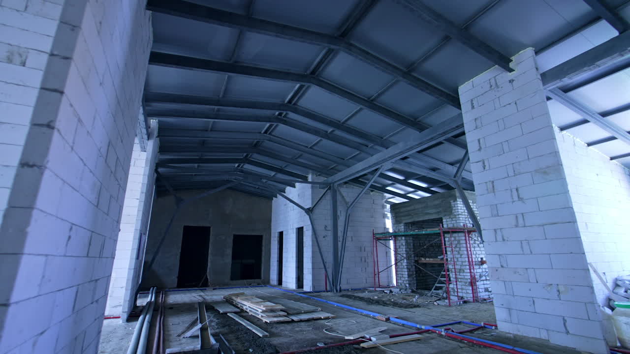 New bulkheads of white bricks built to support the roof of. Attic floor of the building under reconstruction.