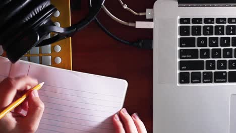 writing on a notebook with pencil overhead