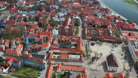 aerial view over red roofs of kaunas city in lithuania - drone shot