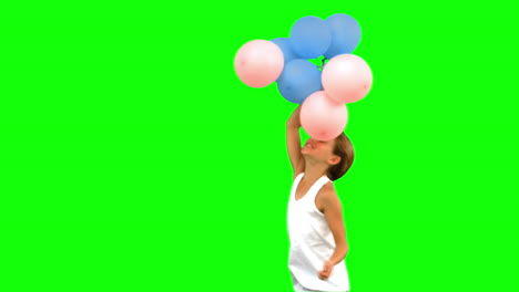 Niña-Jugando-Con-Globos-En-Pantalla-Verde