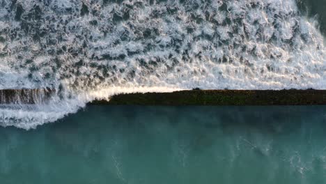 Waikiki-walls-breakwater-crashing-waves-with-white-foam-spilling-over
