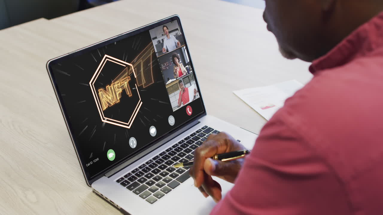 African american businessman using laptop for video call with diverse business colleagues