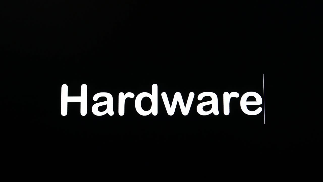 Typing on the screen with a flashing paragraph forming the word Hardware, in white on a black background