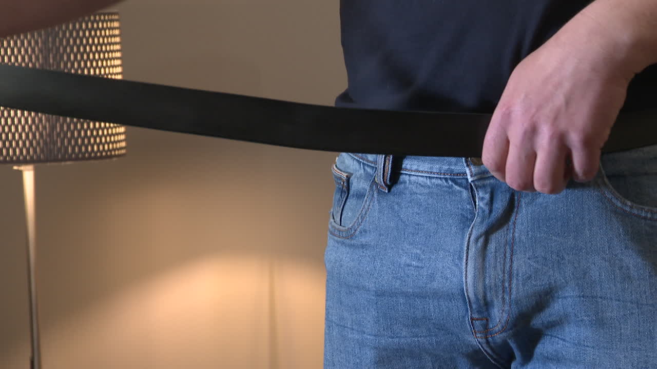 Man Adjusting Belt