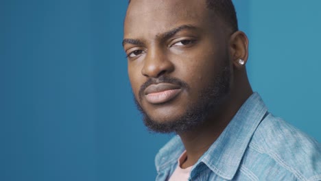 African-man-looking-at-camera-with-dull-expression.