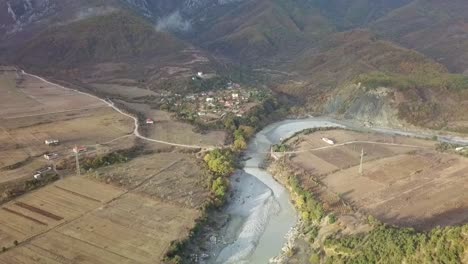 mountain village in albania next to vjose river in the southern area of albania from an aerial view