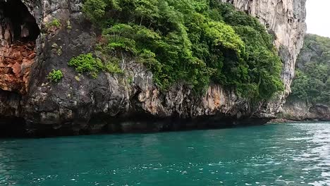 explore vibrant green cliffs and serene emerald waters on a tranquil boat ride.