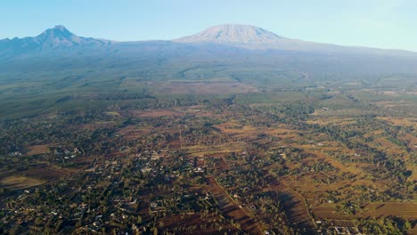 sunrise- kenya landscape with a village, kilimanjaro and amboseli national park - tracking, drone aerial view