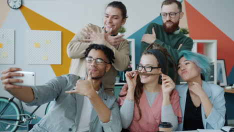 happy coworkers taking a selfie