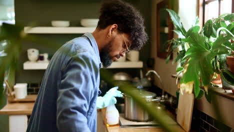 a man cleans the kitchen sink and counter