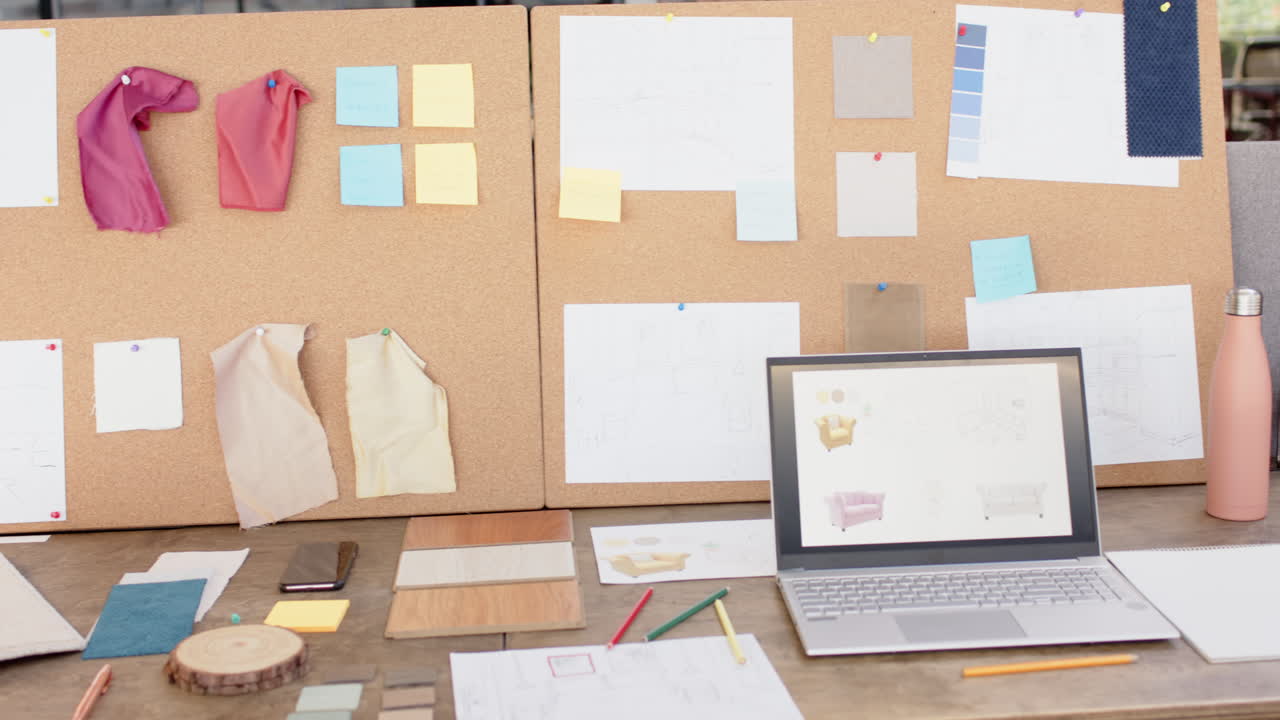 Interior design project, laptop and fabric samples on desk with mood board, at office