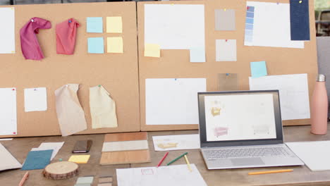 interior design project, laptop and fabric samples on desk with mood board, at office