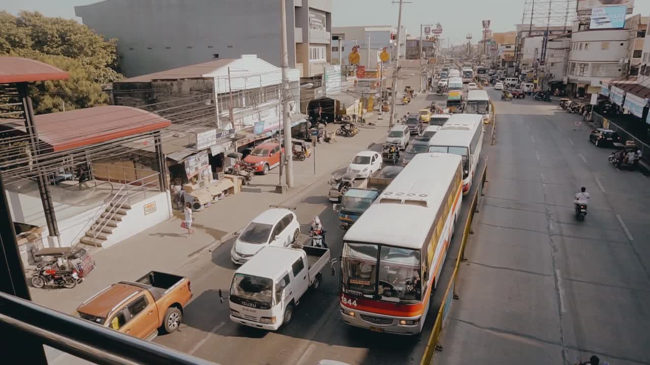 Stabilized cinematic shot from a bridge of vehicle traffic