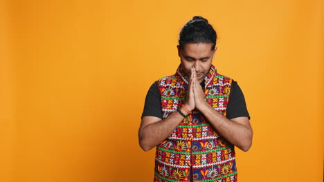 spiritual person doing worship hand gesturing, studio background