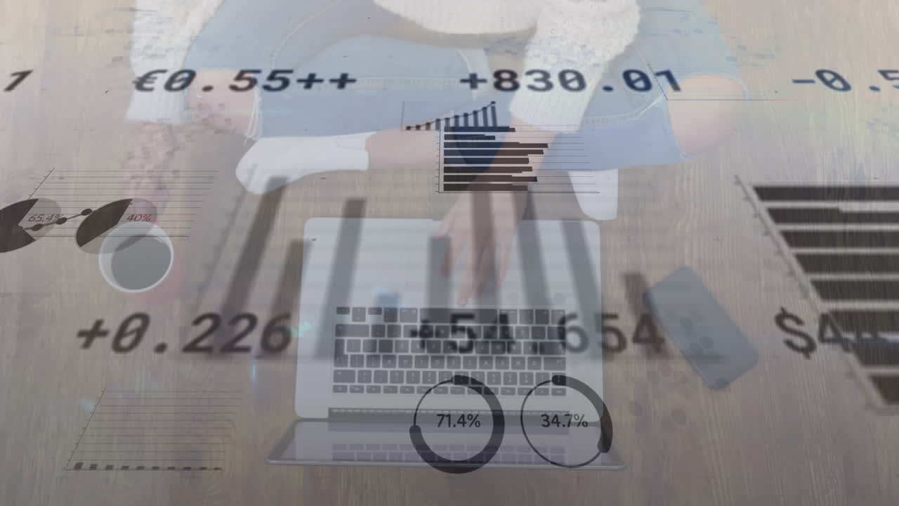 Animation of statistical, stock market data processing against overhead view of woman using a laptop