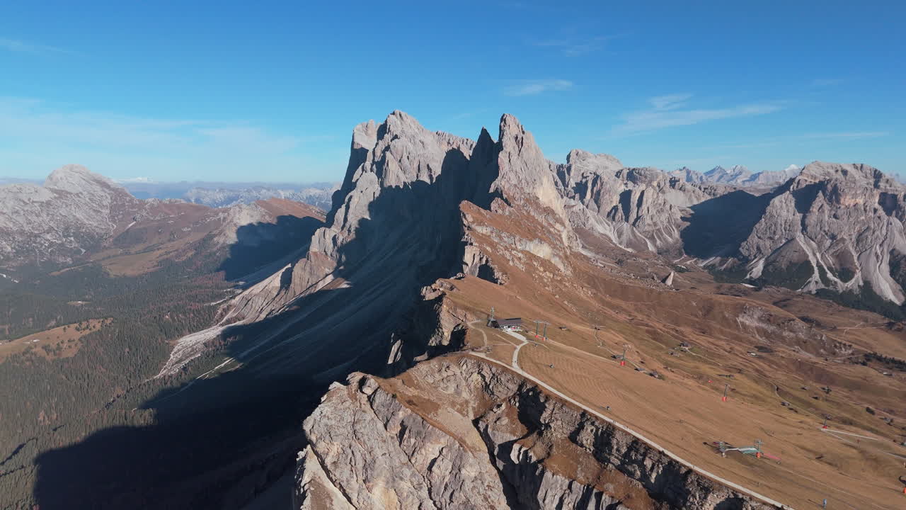 Drone shot in fall of Seceda Ridgeline in rugged Dolomites, Puez-Geisler, Italy
