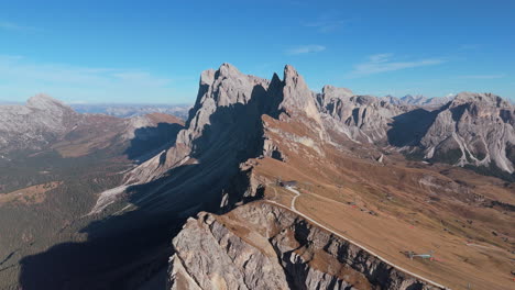 drone shot in fall of seceda ridgeline in rugged dolomites, puez-geisler, italy