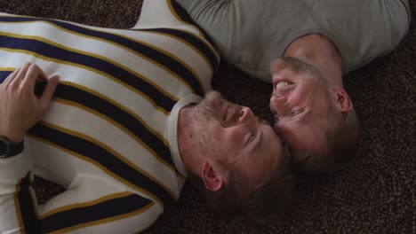 caucasian male couple in social distancing in their sofa at home