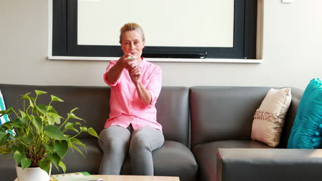 a happy senior woman watching television