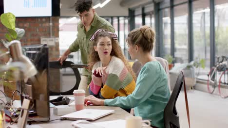 busy diverse business people working on computer and talking in slow motion