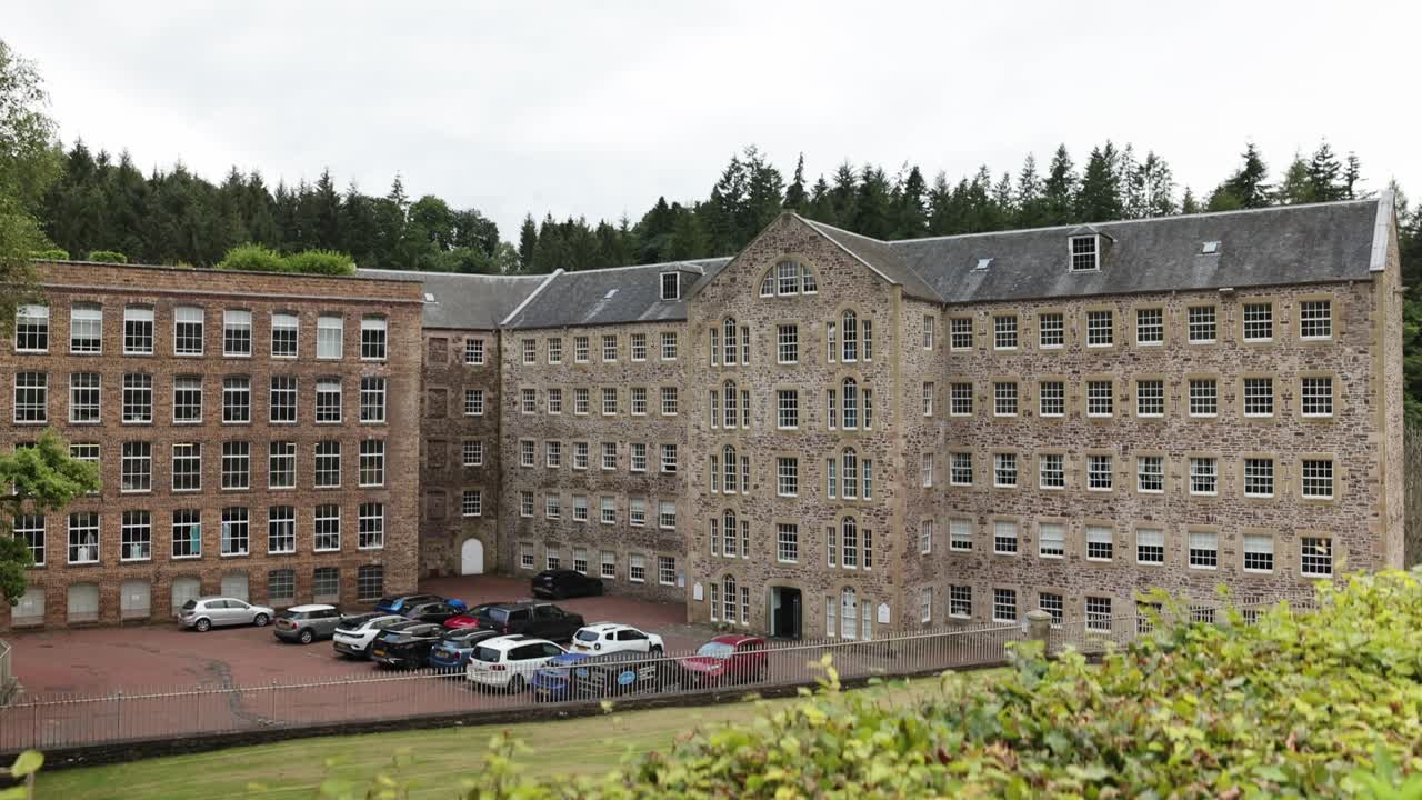 Slow revealing shot of the famous New Lanark Mill Hotel with customers