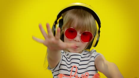 Young-blonde-teen-kid-child-girl-listening-music-via-headphones,-dancing-disco-fooling,-having-fun