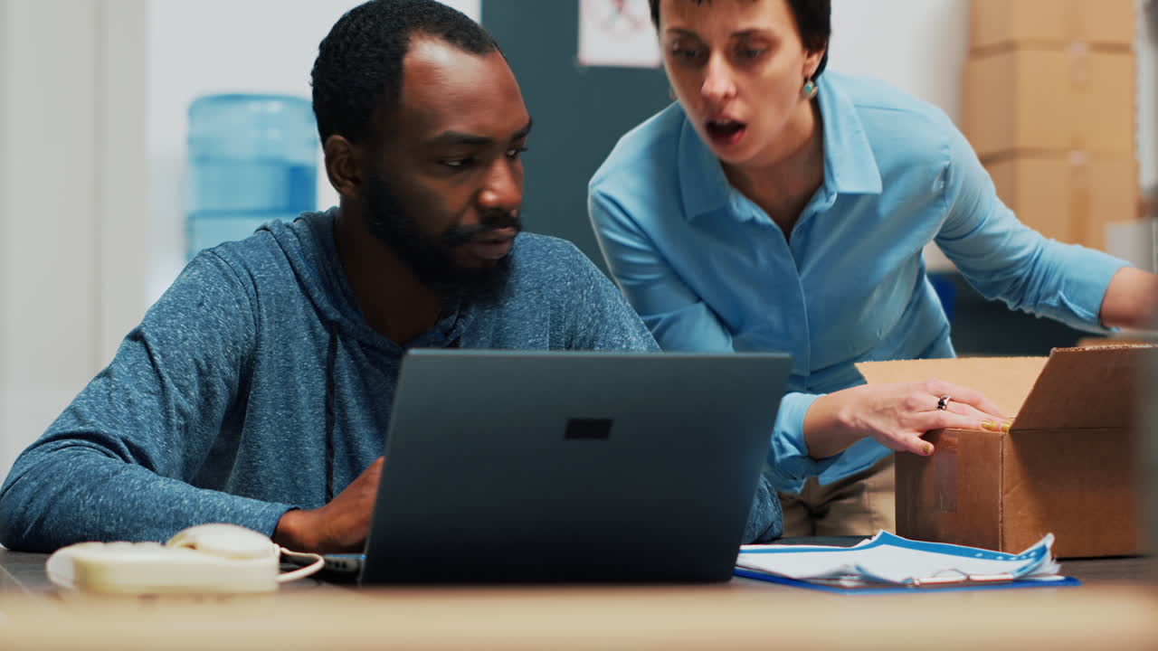 People working with laptop and boxes in office