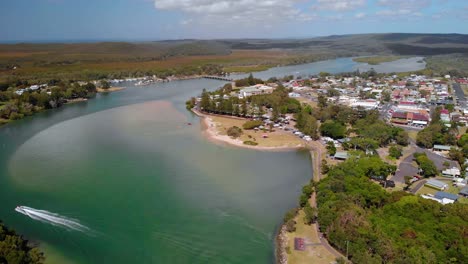 luftaufnahme mit blick auf ein boot auf einem fluss, im evans head village, new south wales, australien - rückseite, drohnenaufnahme