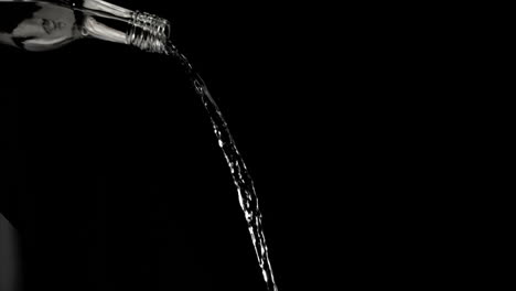trickle of water in a super slow motion falling of the glass bottleneck